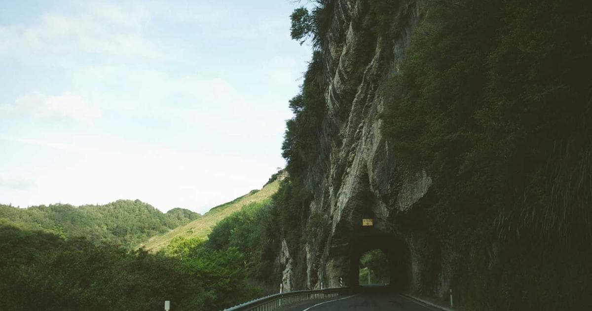 A beautiful tropical beach with a cruise ship in the distance